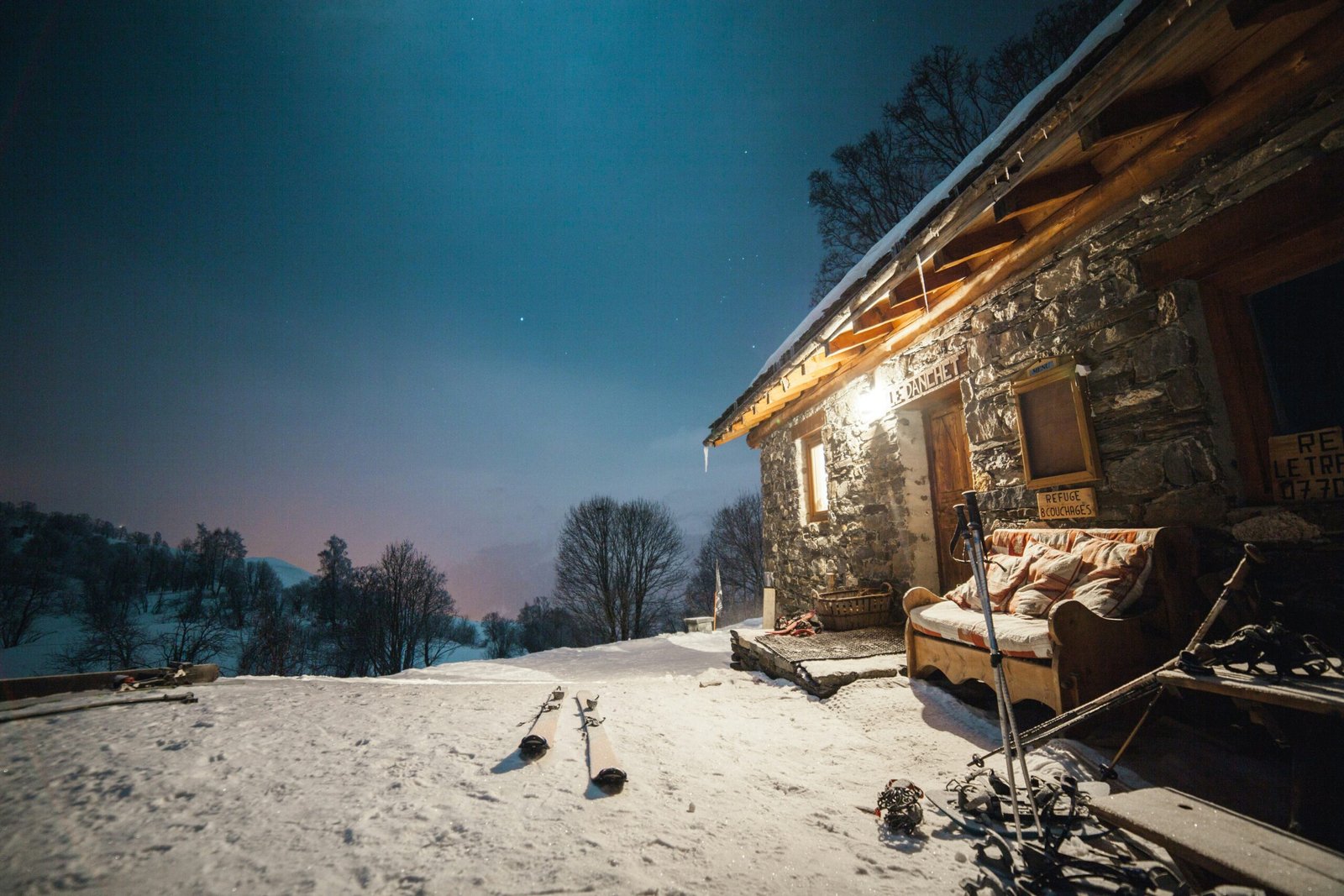 lighted gray house near trees